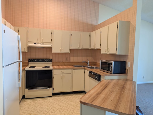 kitchen with white appliances, sink, decorative backsplash, and white cabinets