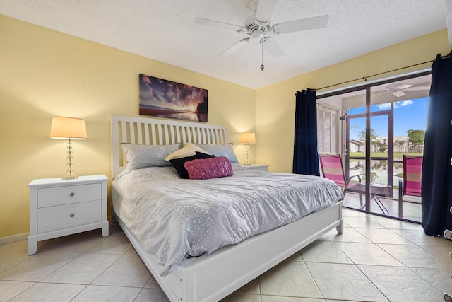 bedroom with access to exterior, tile patterned flooring, a textured ceiling, and baseboards