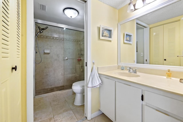 full bath featuring toilet, vanity, visible vents, a closet, and a shower stall