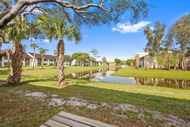 view of yard featuring a water view and a residential view