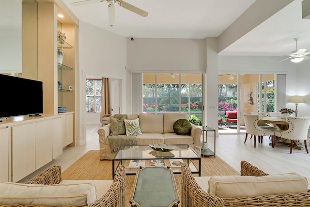 living room featuring ceiling fan and light hardwood / wood-style flooring