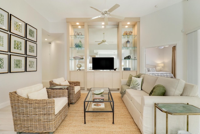 living room with ceiling fan and light wood-type flooring