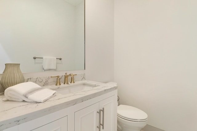 bathroom with vanity and toilet