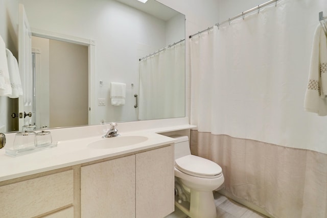 bathroom with vanity, toilet, and a shower with shower curtain