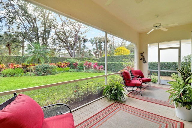 sunroom / solarium featuring lofted ceiling and ceiling fan