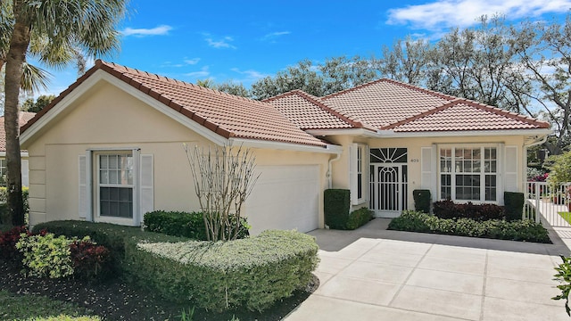 mediterranean / spanish-style house with a garage