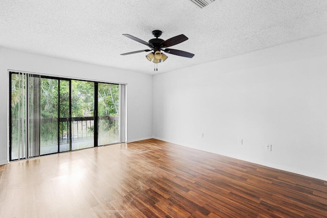 unfurnished room featuring a textured ceiling, wood-type flooring, and ceiling fan