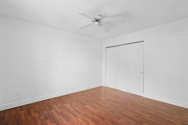 unfurnished room with a textured ceiling, wood-type flooring, and ceiling fan