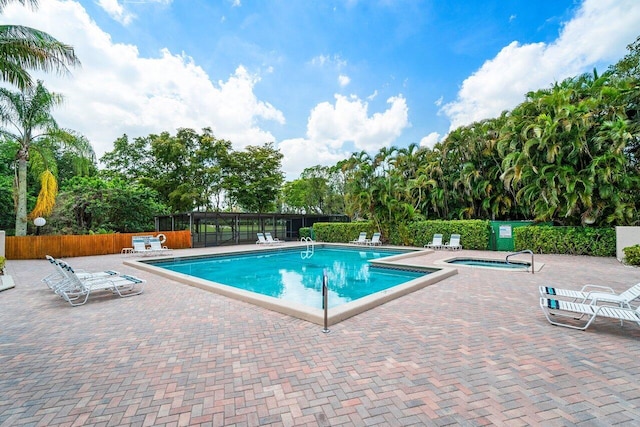 view of swimming pool with a community hot tub and a patio area