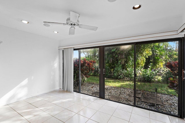 tiled spare room featuring ceiling fan