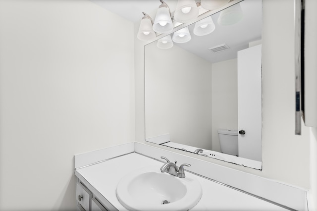 bathroom featuring vanity and toilet