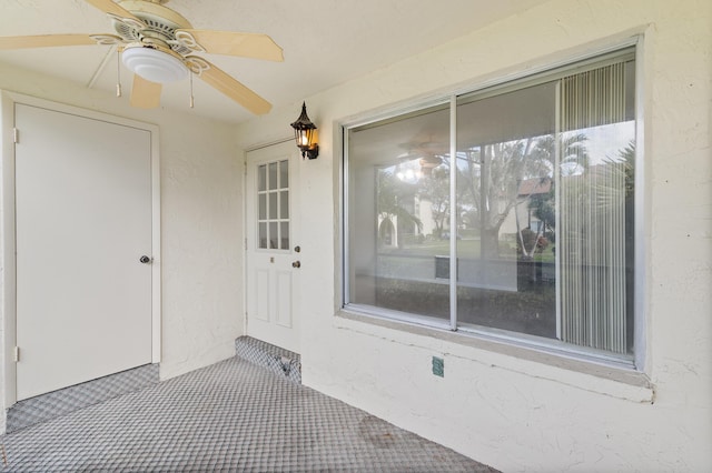 view of exterior entry with ceiling fan