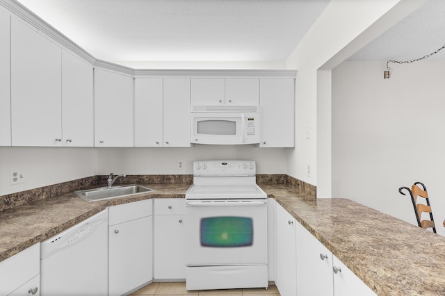 kitchen featuring white cabinetry, sink, light tile patterned flooring, and white appliances