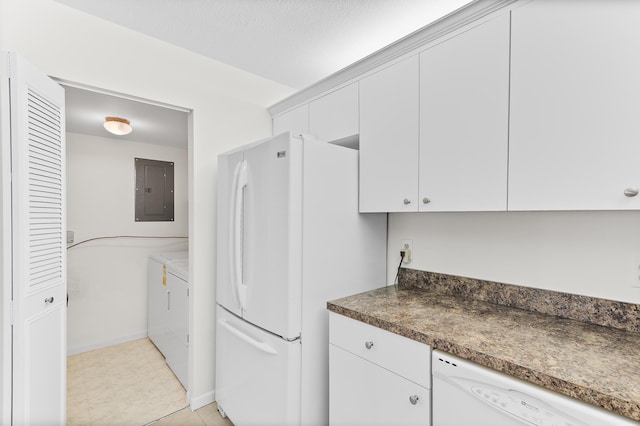 kitchen featuring white appliances, electric panel, washer and dryer, and white cabinets