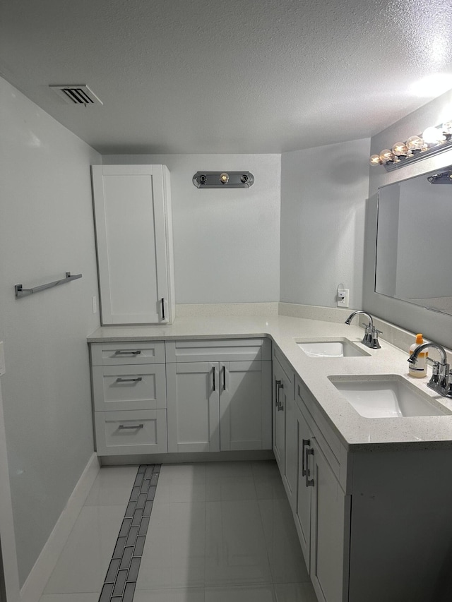 bathroom featuring vanity and a textured ceiling