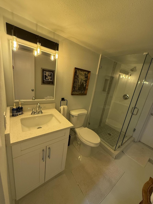 bathroom featuring vanity, toilet, a textured ceiling, and walk in shower