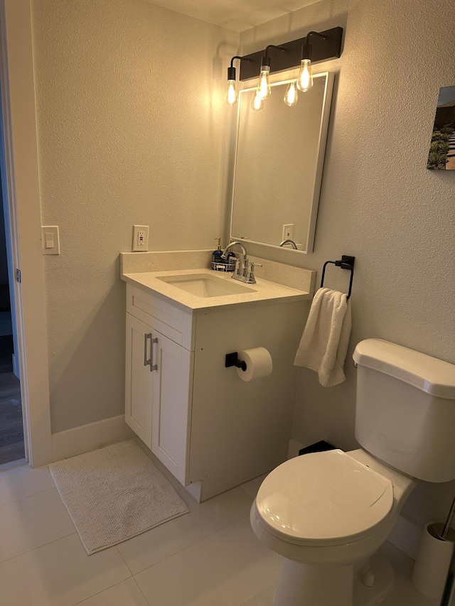 bathroom with tile patterned floors, vanity, and toilet