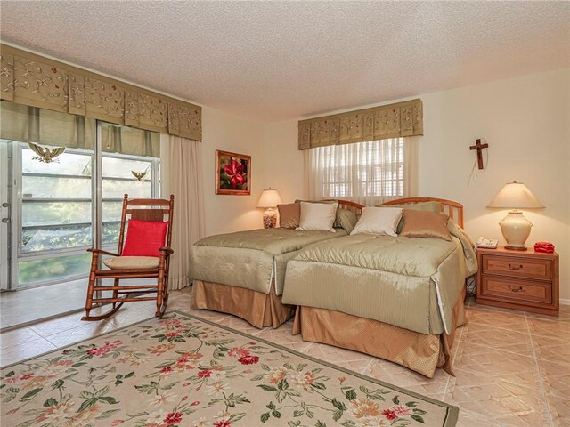 tiled bedroom featuring two closets and a textured ceiling