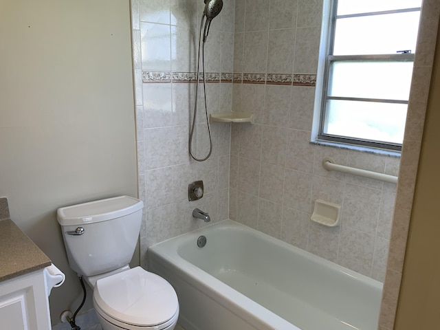 full bathroom with vanity, tiled shower / bath combo, and toilet