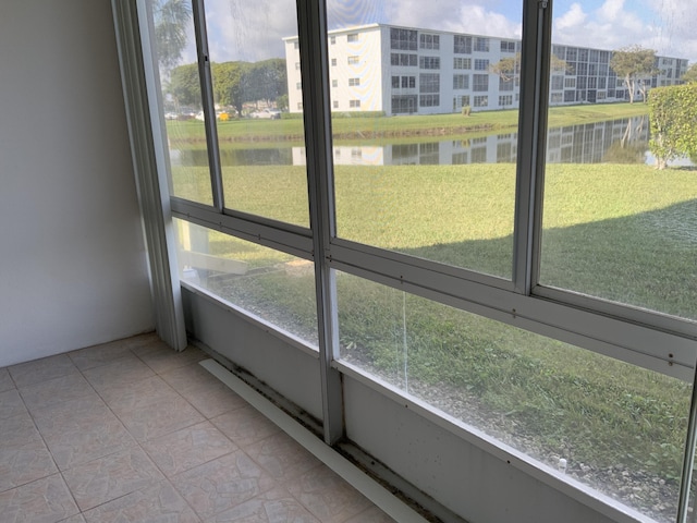 unfurnished sunroom with a water view