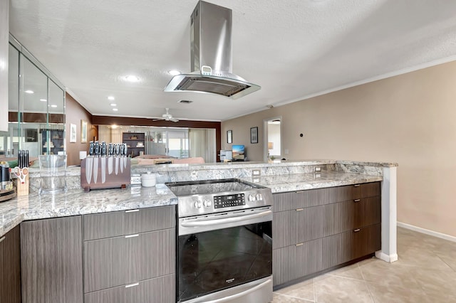 kitchen with light stone counters, island range hood, a textured ceiling, ornamental molding, and stainless steel electric stove