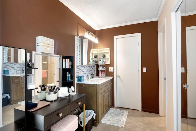 bathroom with tasteful backsplash, tile patterned floors, ornamental molding, and vanity