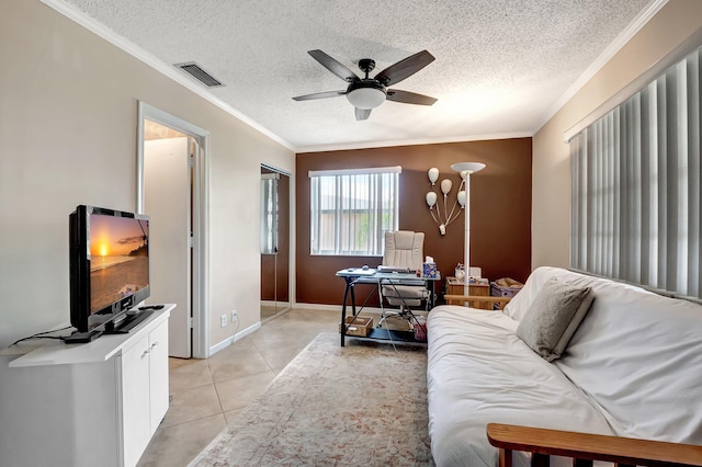 tiled living room featuring ornamental molding, ceiling fan, and a textured ceiling