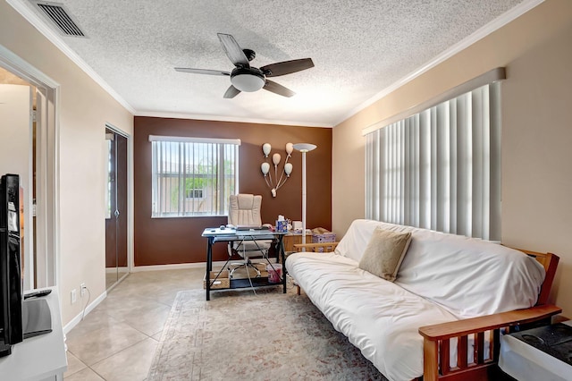 tiled living room featuring ceiling fan, ornamental molding, and a textured ceiling