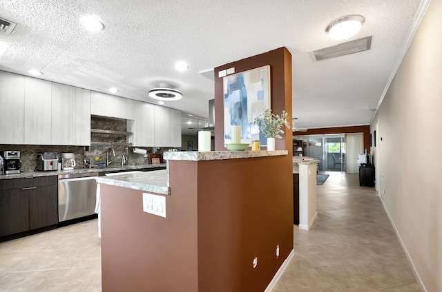 kitchen featuring sink, dishwasher, backsplash, a center island, and ornamental molding