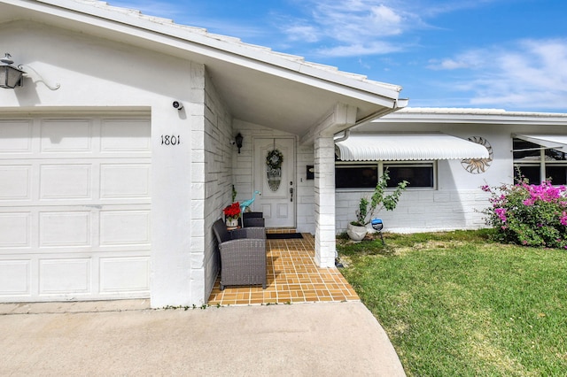 property entrance with a yard and a garage