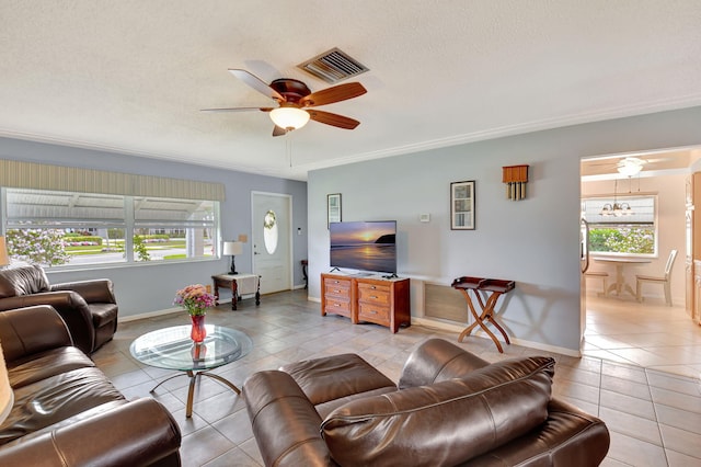 tiled living room with ceiling fan with notable chandelier and a textured ceiling