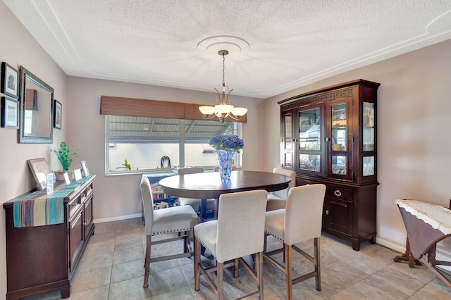 tiled dining room with a notable chandelier, a textured ceiling, and a healthy amount of sunlight