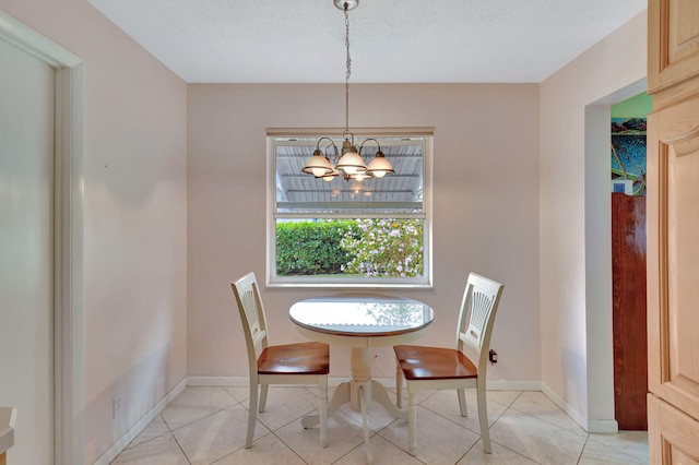 dining space with a notable chandelier and light tile patterned flooring