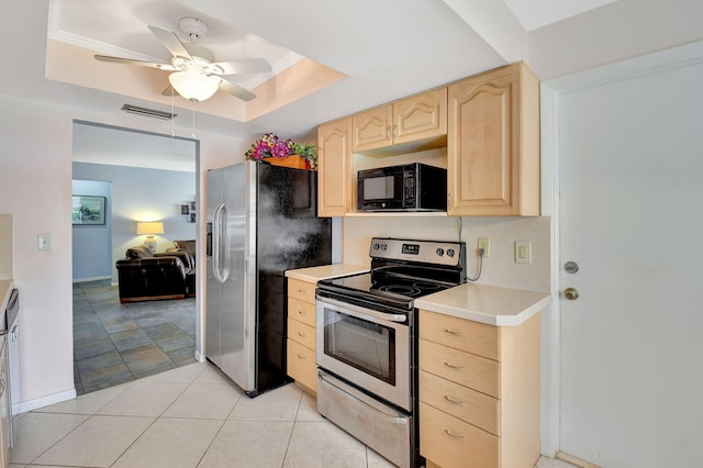 kitchen featuring a raised ceiling, light tile patterned floors, ceiling fan, stainless steel appliances, and light brown cabinets