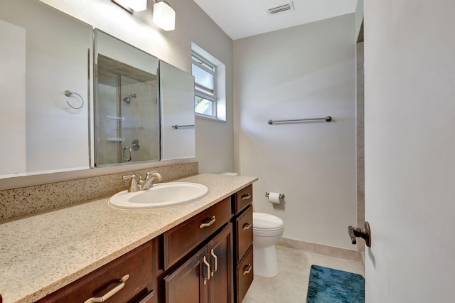 bathroom featuring walk in shower, vanity, toilet, and tile patterned flooring