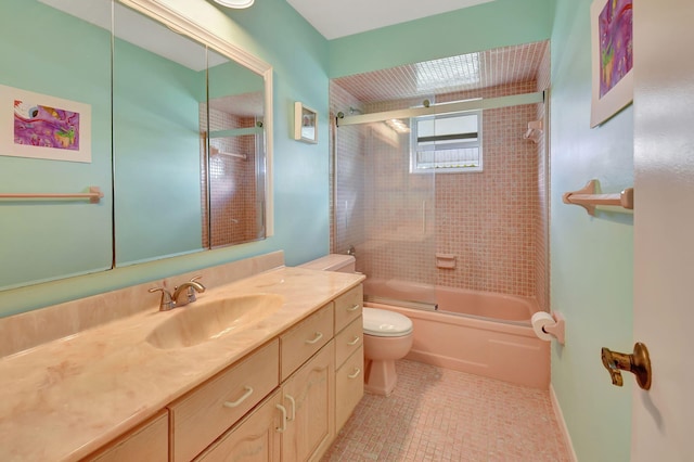 full bathroom featuring vanity, bath / shower combo with glass door, tile patterned floors, and toilet