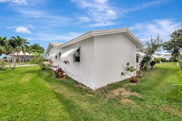 view of property exterior featuring a lawn