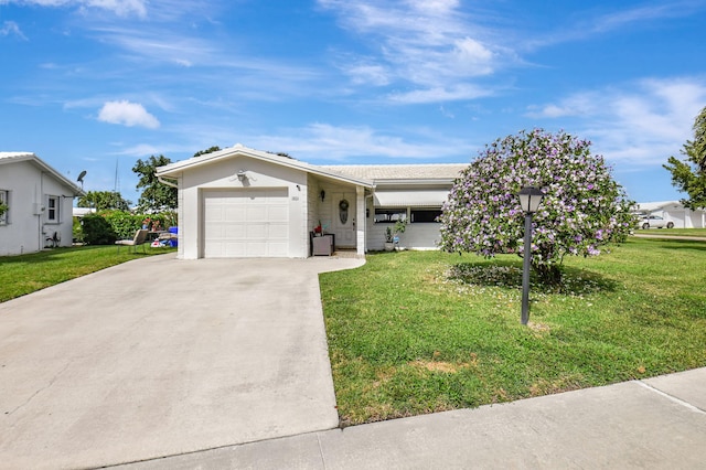 ranch-style house featuring a garage and a front yard