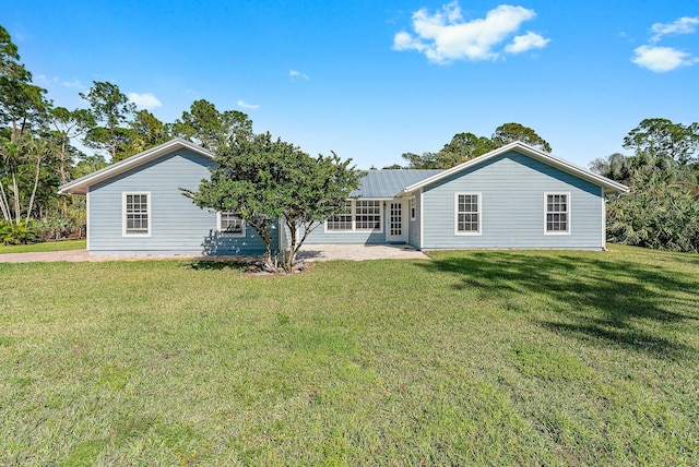 rear view of property with a yard