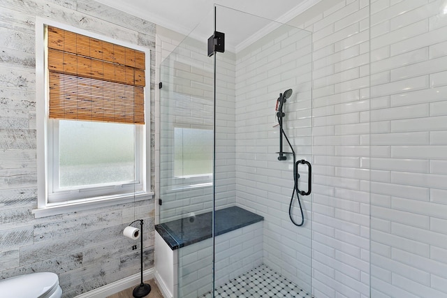 bathroom featuring an enclosed shower, crown molding, and toilet