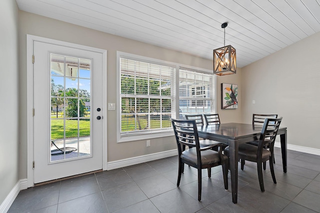 dining space featuring dark tile patterned flooring and a wealth of natural light