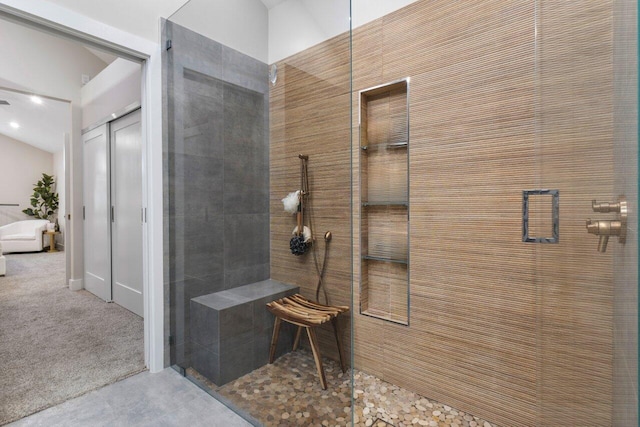 bathroom with a shower with door