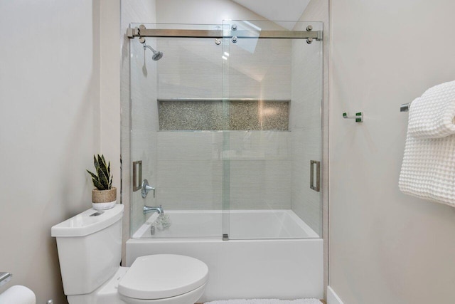 bathroom with enclosed tub / shower combo and toilet