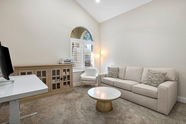 carpeted living room featuring high vaulted ceiling