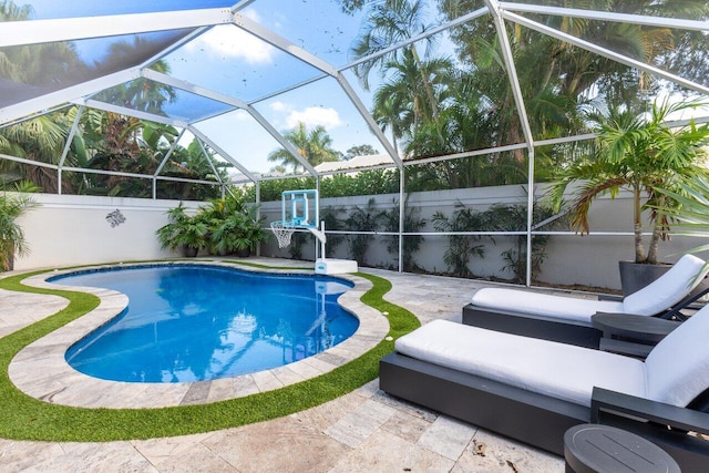 view of pool featuring glass enclosure and a patio area