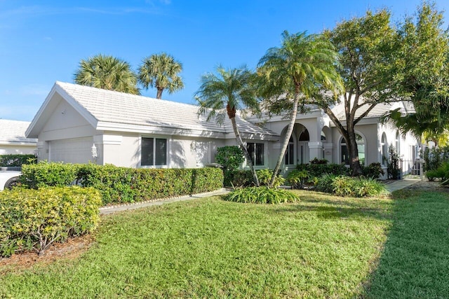 view of front of home featuring a garage and a front yard