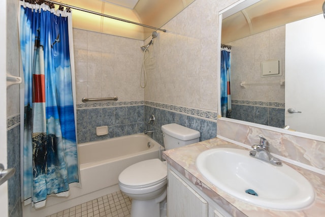 full bathroom with toilet, tile walls, vanity, shower / bath combo with shower curtain, and tile patterned flooring