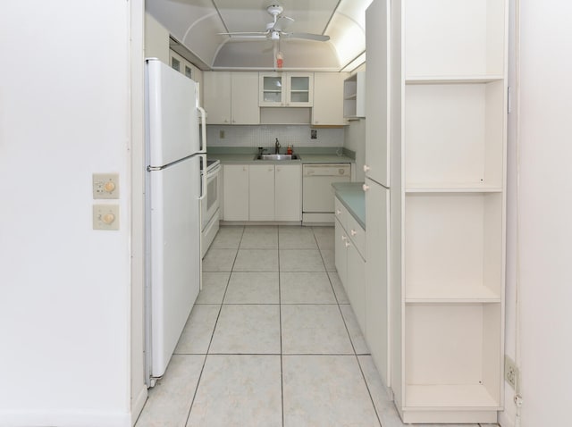 kitchen with sink, white appliances, ceiling fan, white cabinets, and light tile patterned flooring