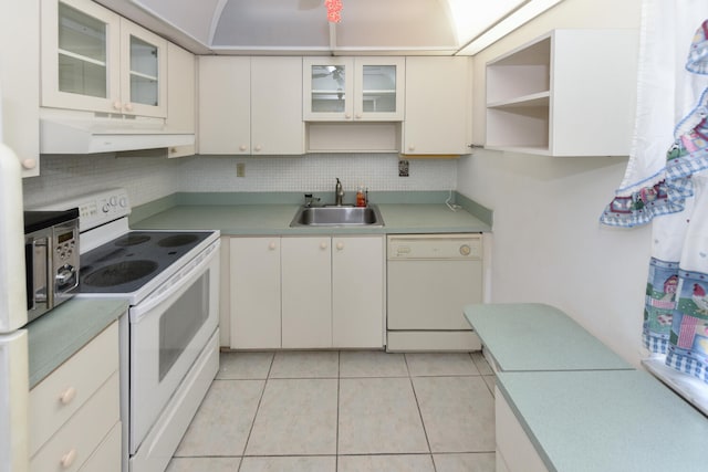 kitchen with white cabinetry, sink, backsplash, light tile patterned floors, and white appliances