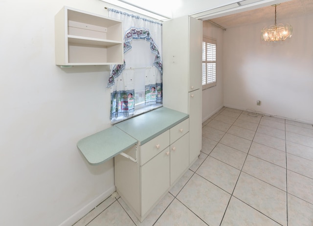 kitchen with light tile patterned floors, decorative light fixtures, and a notable chandelier